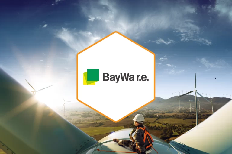 BayWa r.e. logo set on a white hexagon against a windmill plant backdrop
