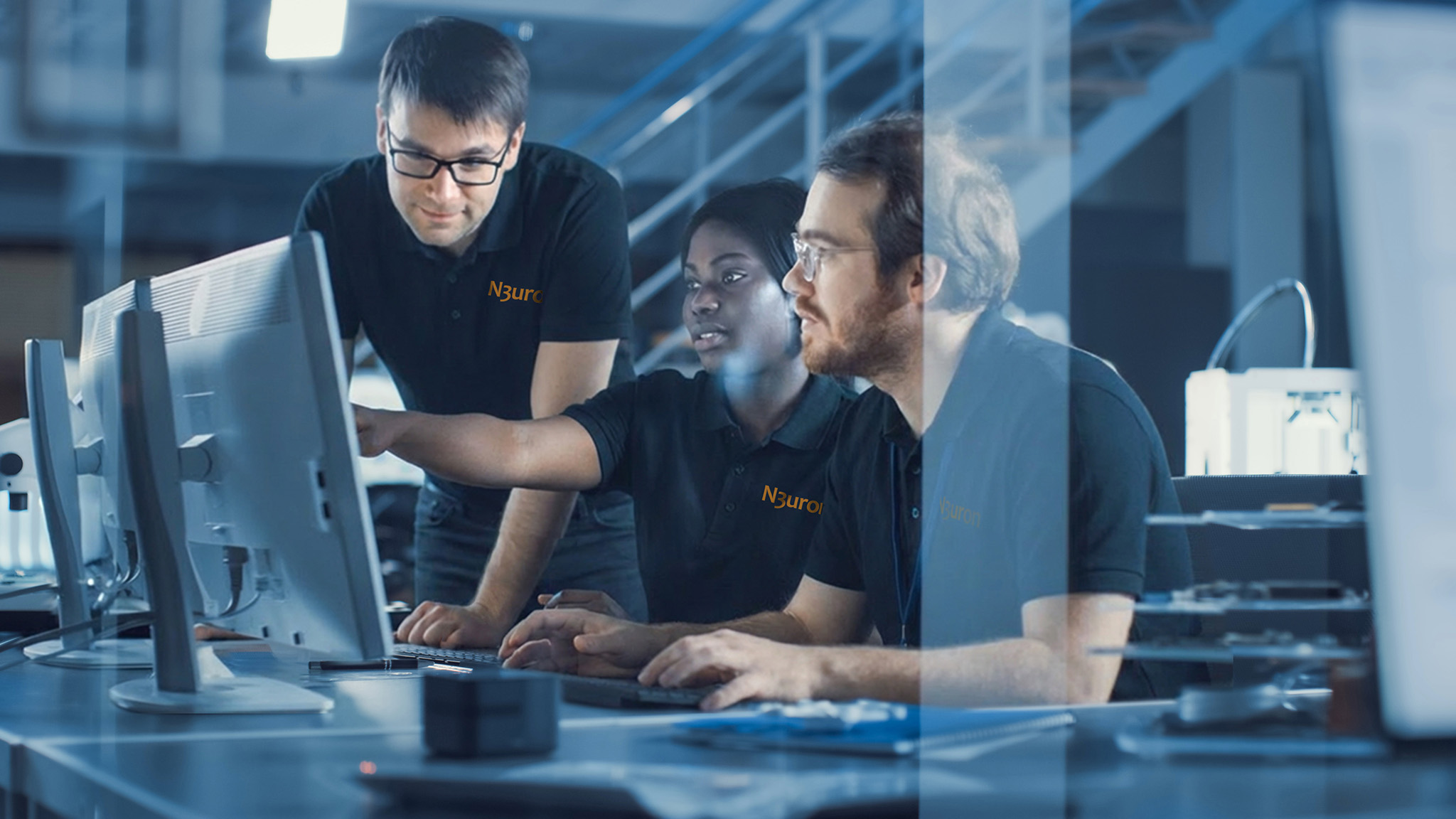 Three N3uron engineers collaborating at workstations in a technical environment, representing the team behind N3uron secure software development practices